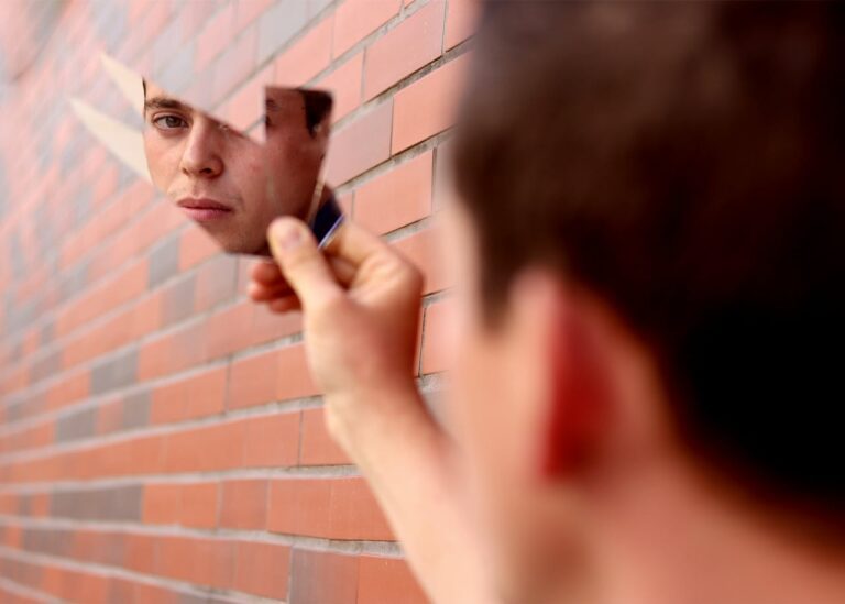 Man looking in broken mirror, rebuilding healthy sexuality