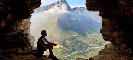 Guy sitting in a mountain cave opening, life after porn